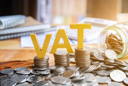 Vat Concept.Word vat with stacked coins there is a notebook calc